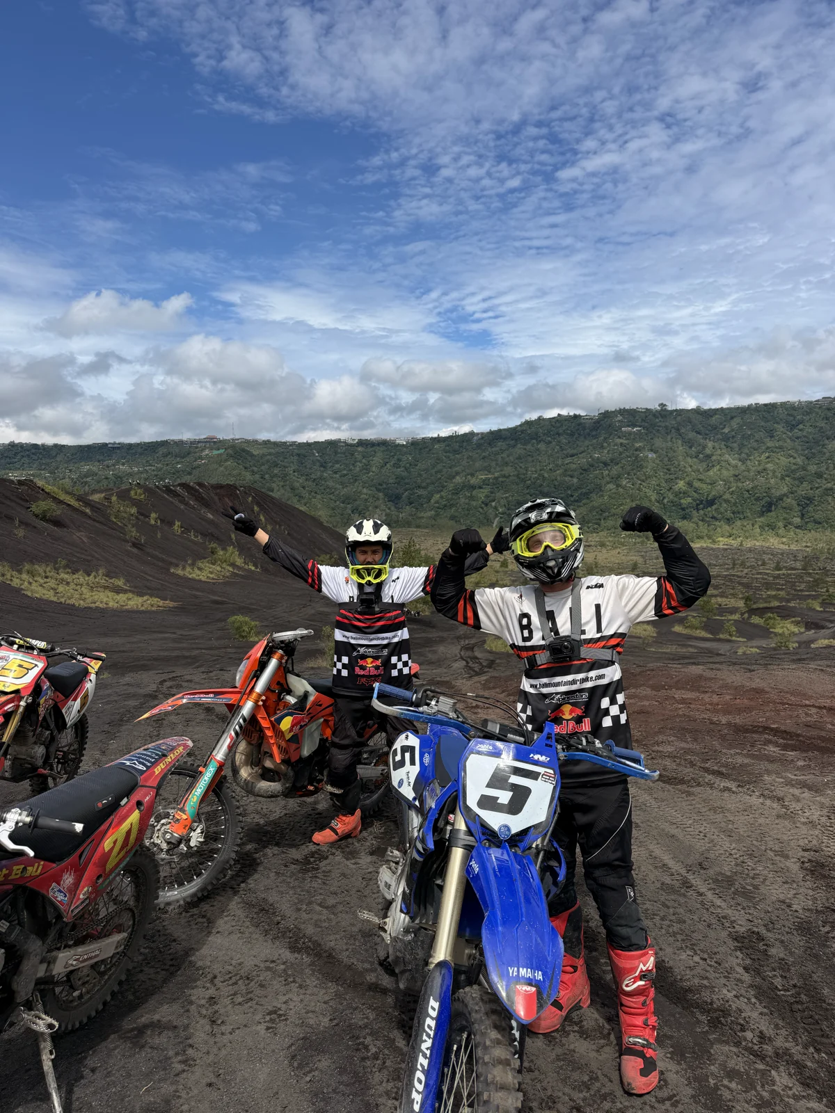 Top of the climb | Two riders celebrating beside their dirt bikes on the volcanic slopes of the Kintamani highlands in Bali, sober adventure travel, Nomadic Addictt. Top of the climb | Two riders celebrating beside their dirt bikes on the volcanic slopes of the Kintamani highlands in Bali, sober adventure travel, Nomadic Addictt.