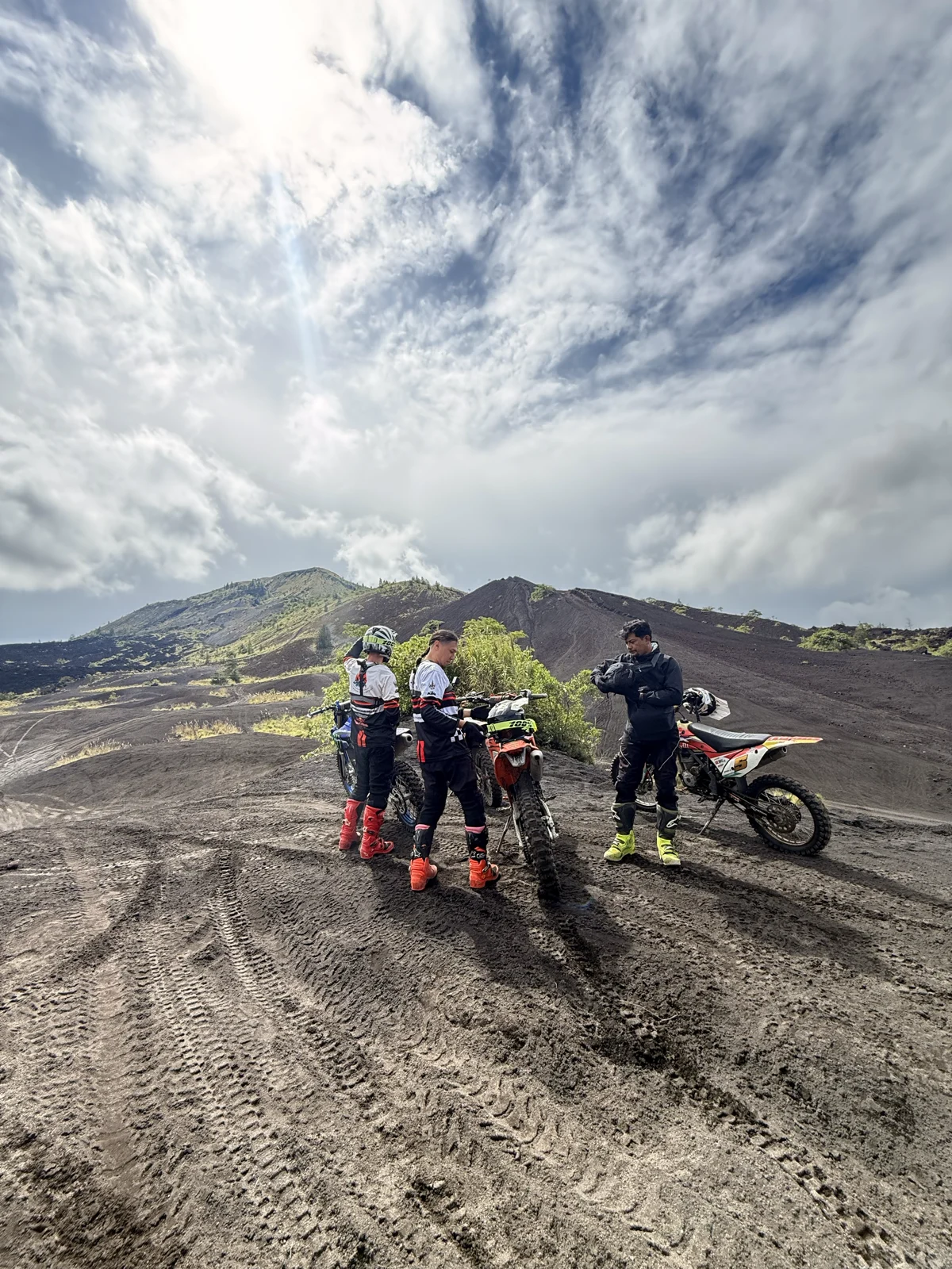 Out on the open slope | Riders and dirt bikes on the black volcanic terrain below Mount Batur, Kintamani, Bali, sober travel adventure. Out on the open slope | Riders and dirt bikes on the black volcanic terrain below Mount Batur, Kintamani, Bali, sober travel adventure.